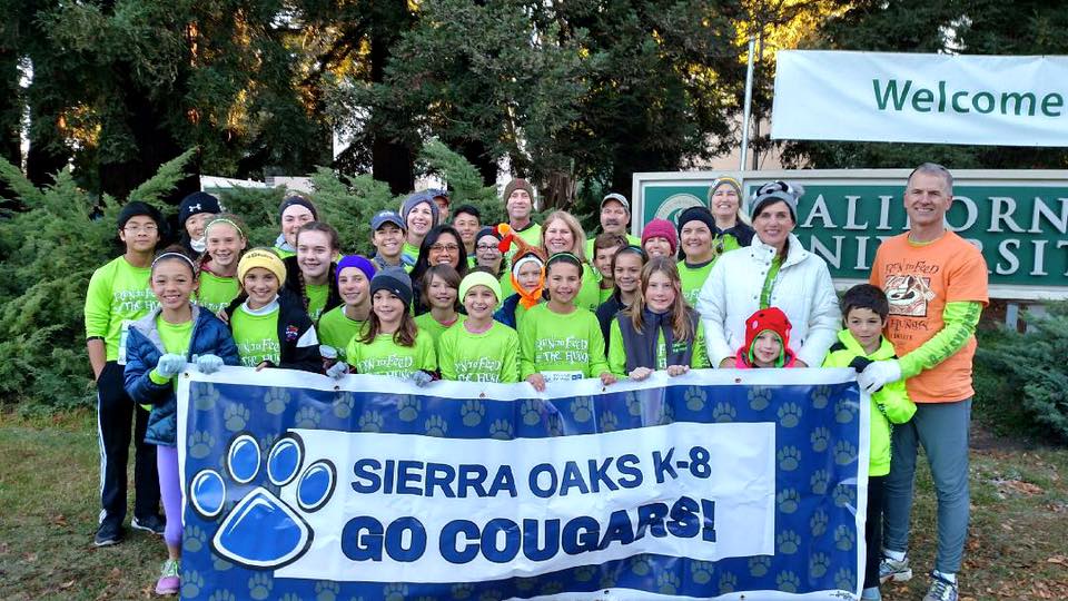 Photo of Sierra Oaks K-8 students and parents standing with a "Go Cougars" banner.